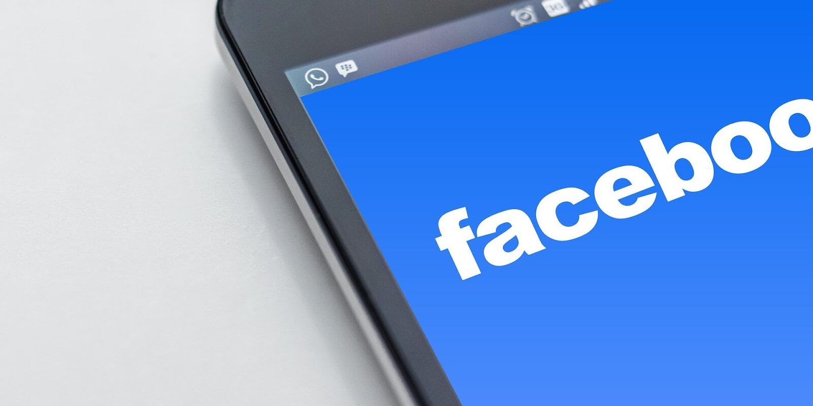 Jeff 2 Facebook logo on the mobile screen represents how to rank posts on top of Facebook news feeds.